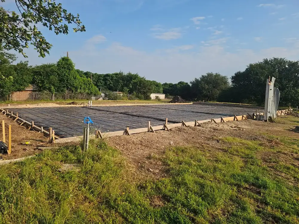 A rebar grid tied and formed across a large slab pour ready for concrete